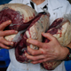 A butcher carries out rump steak cuts.